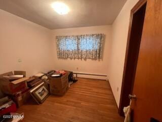 misc room with baseboard heating and wood-type flooring