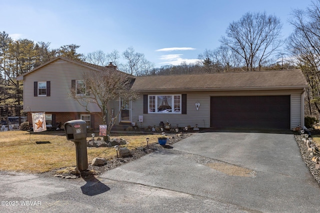 split level home with a shingled roof, a front lawn, aphalt driveway, a chimney, and a garage