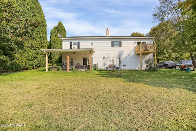 back of property with a yard and a chimney