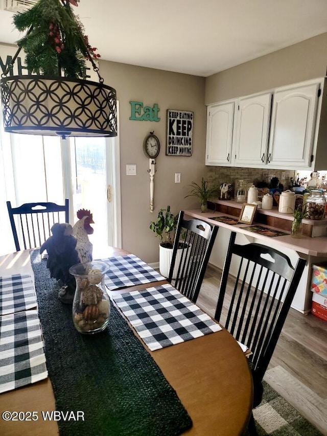 dining space with dark wood-style flooring