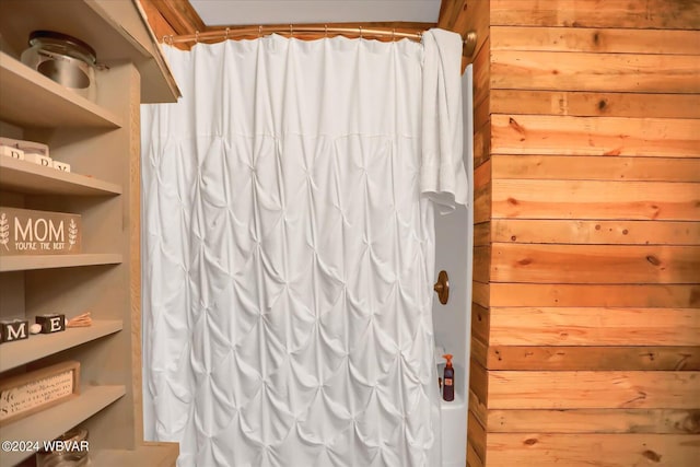 bathroom with wood walls