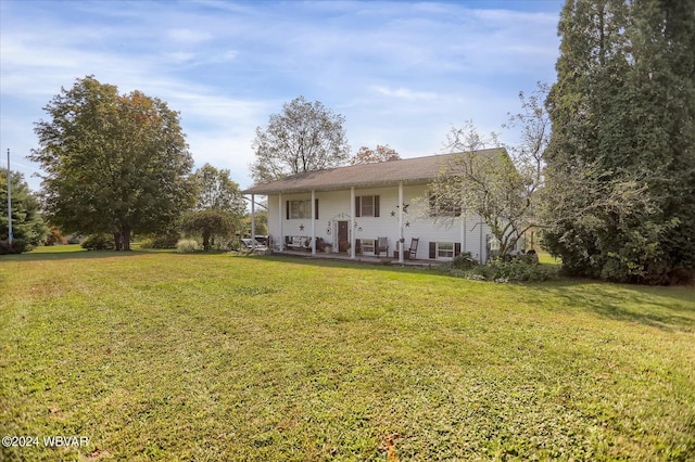 back of house featuring a lawn