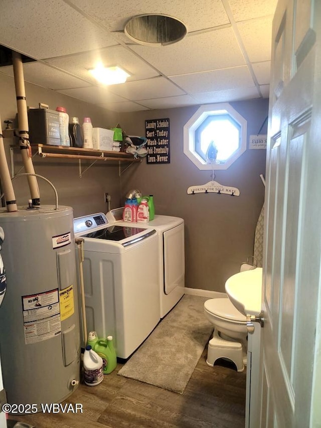 laundry area featuring laundry area, wood finished floors, electric water heater, and washer and dryer