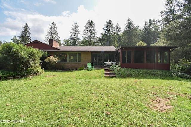 715 Park Ave, Lock Haven, PA 17745 - rear view of property with a sunroom, a yard, a chimney, and brick siding