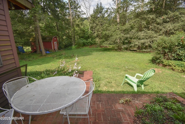 715 Park Ave, Lock Haven, PA 17745 - view of green lawn with a storage unit, a patio area, and outdoor dining space