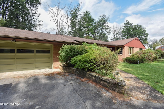 715 Park Ave, Lock Haven, PA 17745 - ranch-style home with brick siding, a shingled roof, a garage, a front lawn, and asphalt driveway