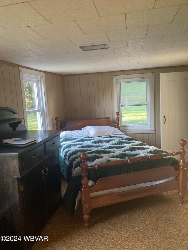 bedroom with wood walls