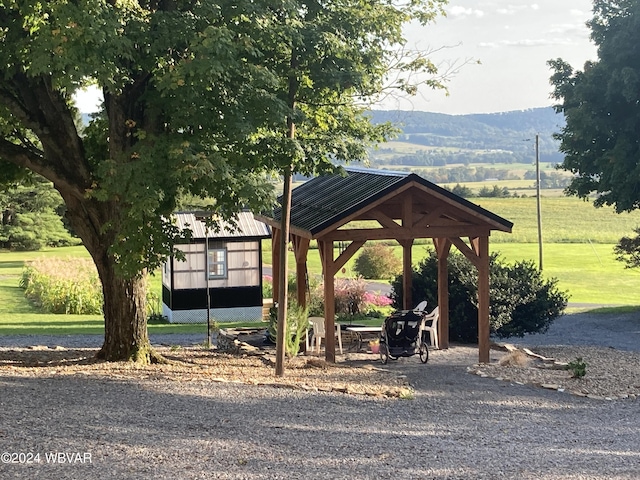 surrounding community featuring a gazebo and a mountain view