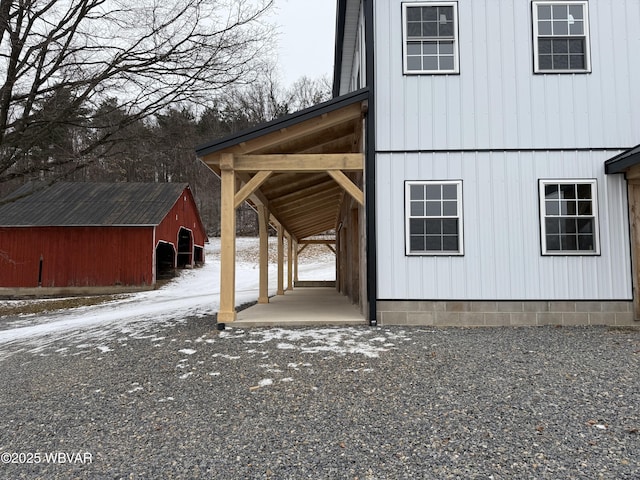 snow covered property with an outdoor structure