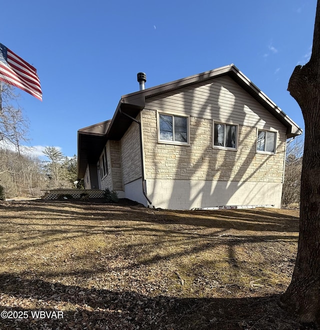 view of side of property with stone siding