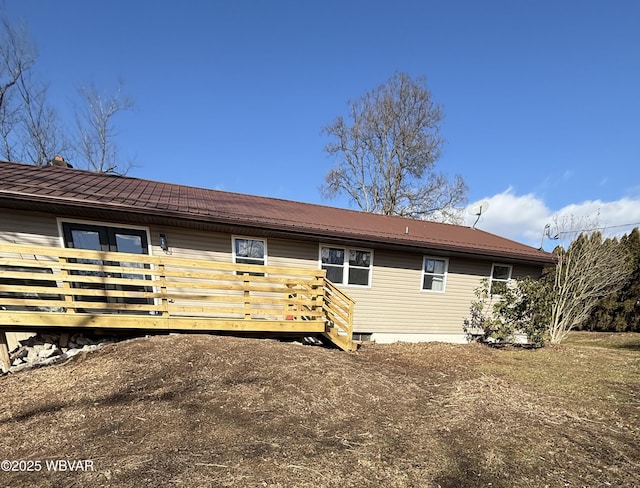 exterior space featuring a deck and metal roof