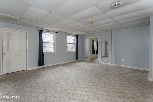 unfurnished room with carpet and a paneled ceiling