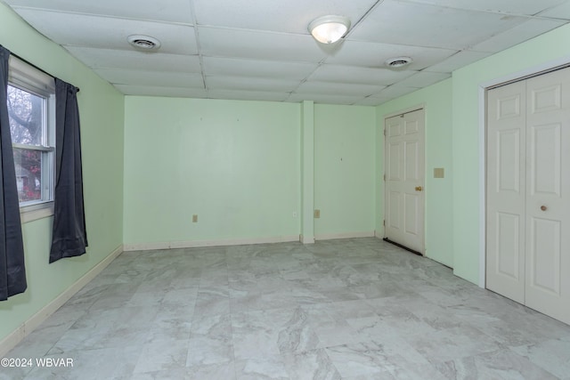 spare room with a paneled ceiling