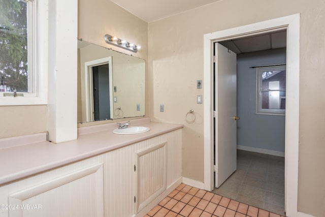 bathroom featuring vanity, a healthy amount of sunlight, and tile patterned floors