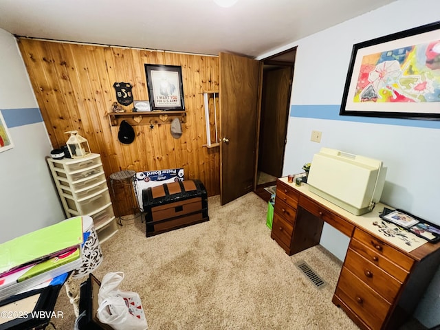 carpeted office space with wooden walls