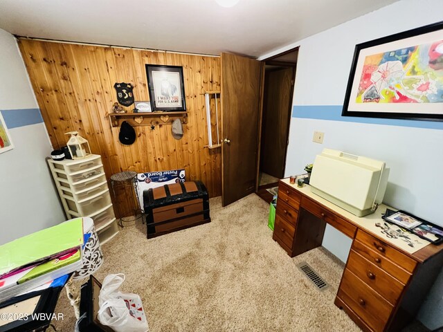 carpeted office space with wooden walls