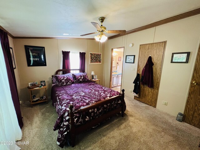 carpeted bedroom with ensuite bath, ceiling fan, and crown molding