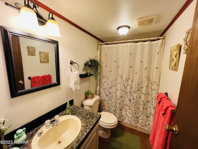 bathroom featuring a shower with curtain, vanity, crown molding, wood-type flooring, and toilet