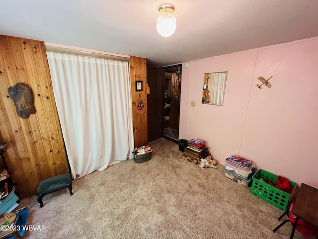 game room featuring carpet flooring and wood walls