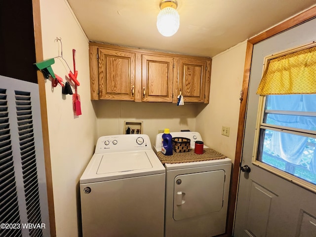 laundry area with washing machine and dryer and cabinets