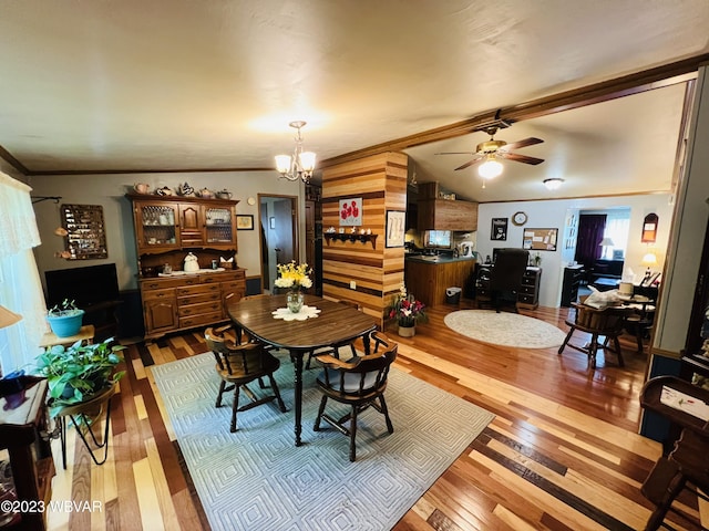 dining room with hardwood / wood-style floors, ceiling fan with notable chandelier, and ornamental molding