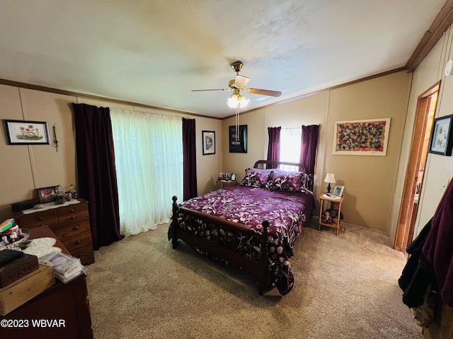 bedroom with ceiling fan, carpet floors, and ornamental molding