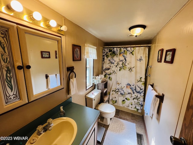 full bathroom with tile patterned floors, vanity, toilet, and shower / bath combo