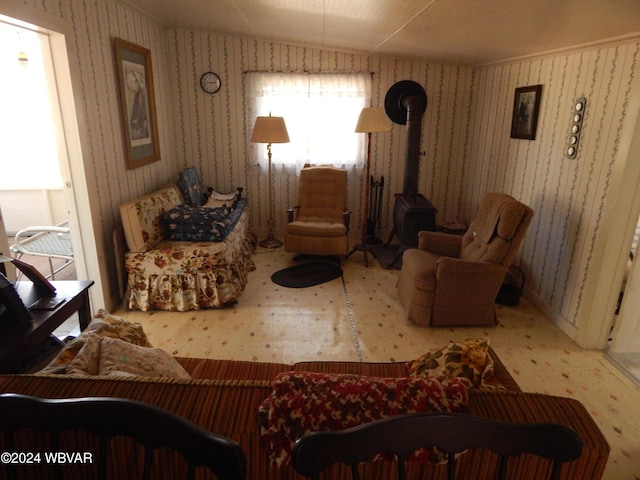 living area featuring a wood stove and vaulted ceiling