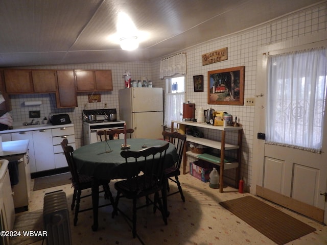 dining area featuring tile walls