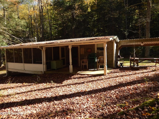 exterior space featuring a sunroom and a patio