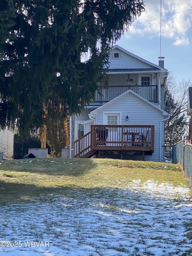 exterior space with a wooden deck and a lawn