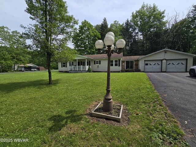 4316 Pine Mountain Rd, Jersey Shore, PA 17740 - view of front of house featuring covered porch, asphalt driveway, an attached garage, and a front lawn