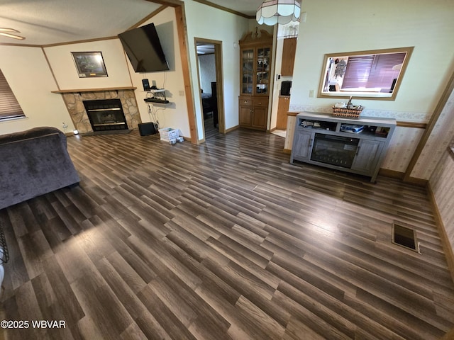 4316 Pine Mountain Rd, Jersey Shore, PA 17740 - unfurnished living room featuring a stone fireplace, dark wood-type flooring, ornamental molding, and baseboards