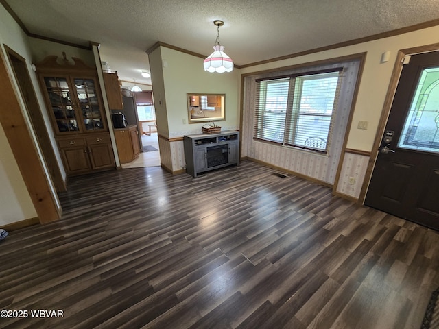 4316 Pine Mountain Rd, Jersey Shore, PA 17740 - unfurnished dining area featuring ornamental molding, dark wood-type flooring, a textured ceiling, healthy amount of natural light, and a wainscoted wall