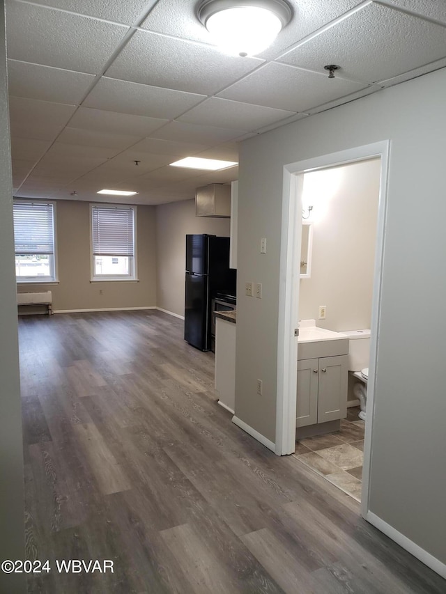 interior space with hardwood / wood-style floors and a drop ceiling