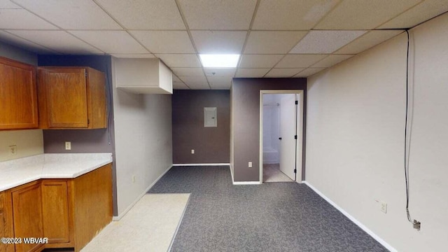 interior space featuring light carpet and a drop ceiling