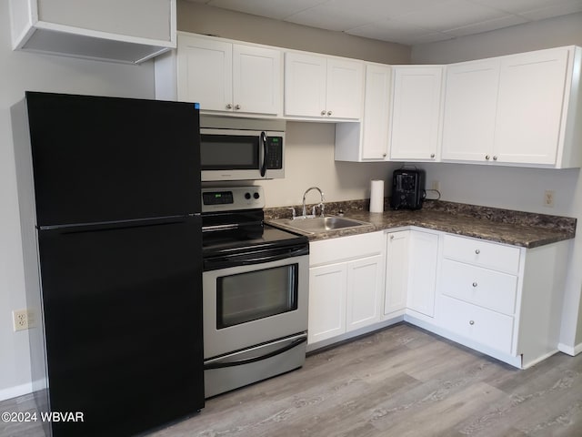 kitchen featuring white cabinetry, sink, appliances with stainless steel finishes, and light hardwood / wood-style flooring