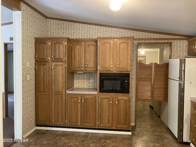 400 Livermore Rd, Williamsport, PA 17701 - kitchen with freestanding refrigerator, black microwave, ornamental molding, and lofted ceiling