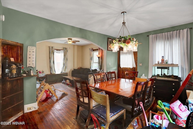 679 2nd Ave, Williamsport, PA 17701 - dining space with radiator, arched walkways, hardwood / wood-style flooring, and plenty of natural light