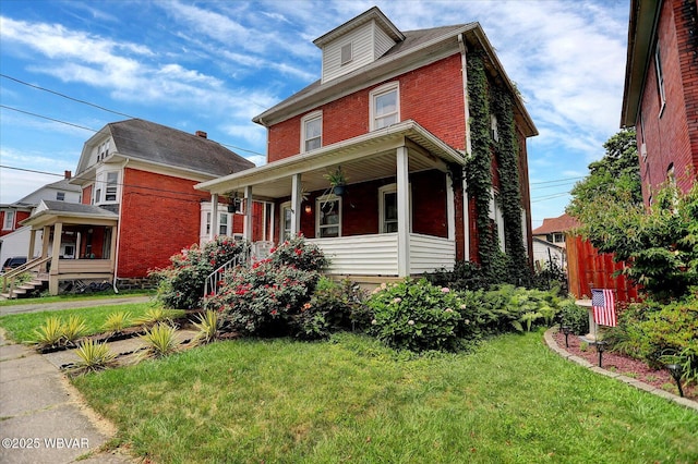 679 2nd Ave, Williamsport, PA 17701 - traditional style home with brick siding, a front yard, and a porch
