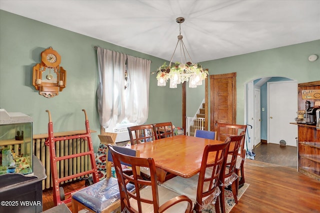 679 2nd Ave, Williamsport, PA 17701 - dining room with arched walkways, wood finished floors, a chandelier, and stairs