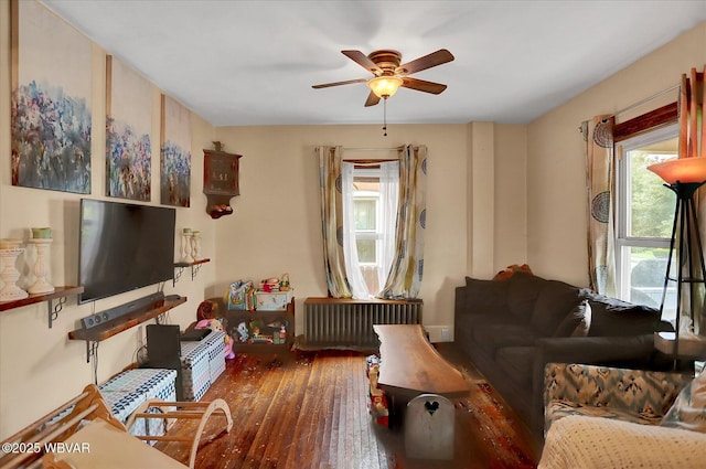 679 2nd Ave, Williamsport, PA 17701 - living area with radiator, plenty of natural light, ceiling fan, and wood-type flooring
