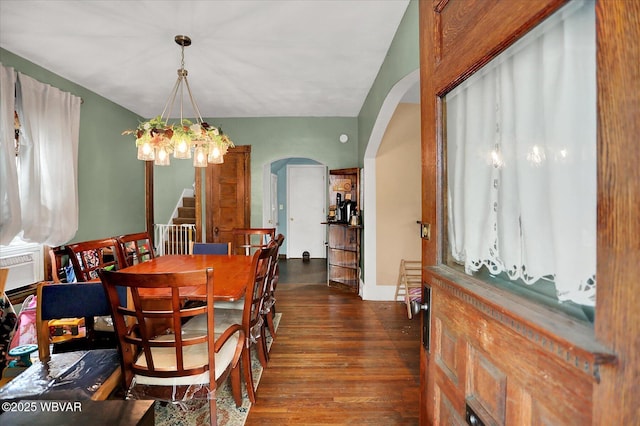 679 2nd Ave, Williamsport, PA 17701 - dining area featuring arched walkways, stairway, dark wood-type flooring, and a chandelier