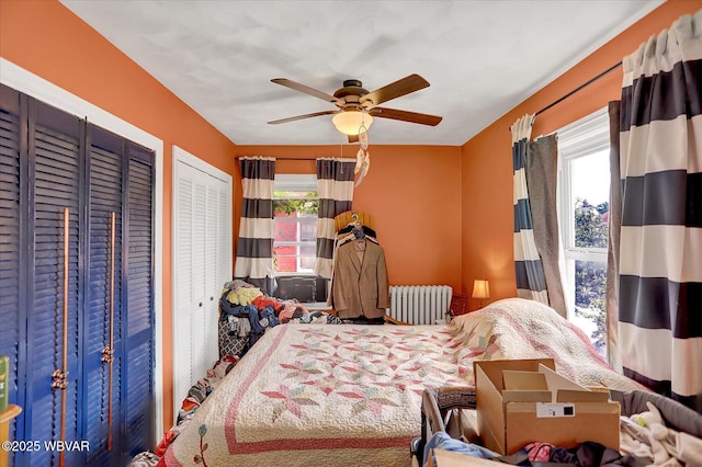 679 2nd Ave, Williamsport, PA 17701 - bedroom with radiator heating unit, multiple windows, two closets, and a ceiling fan