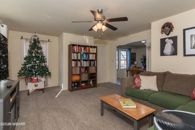 living room featuring carpet flooring and ceiling fan