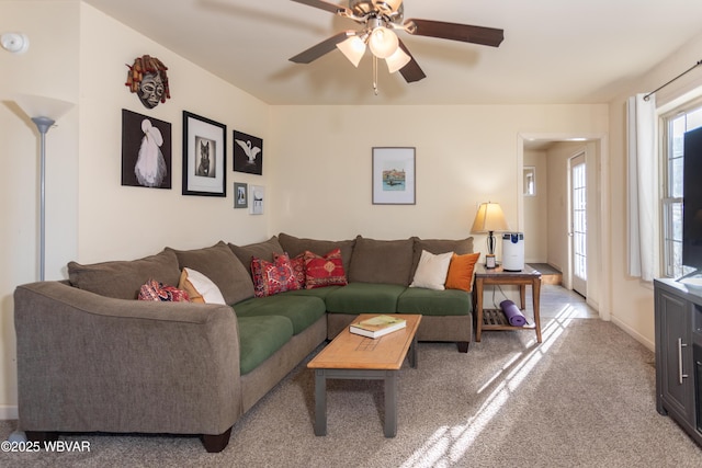 carpeted living room featuring ceiling fan