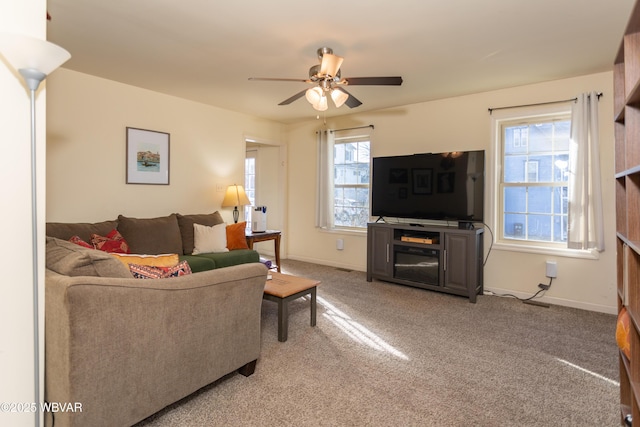 carpeted living room with a wealth of natural light and ceiling fan