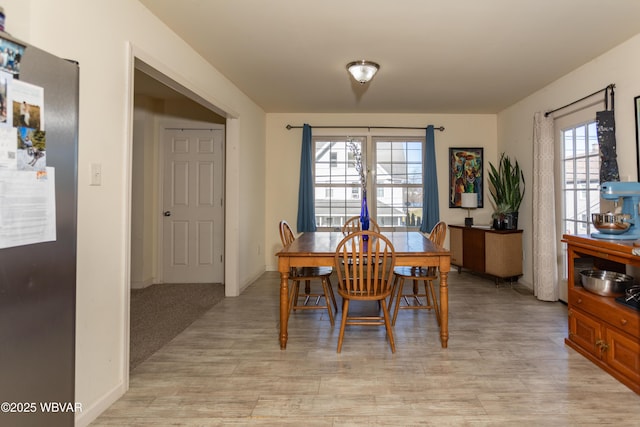 dining space featuring a healthy amount of sunlight and light hardwood / wood-style flooring