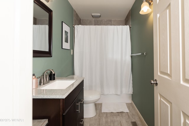 full bathroom with vanity, wood-type flooring, shower / bath combo, and toilet