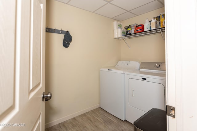 washroom with washer and dryer and light hardwood / wood-style flooring